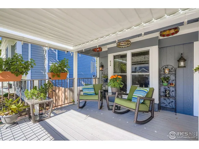 a living room with furniture and potted plants