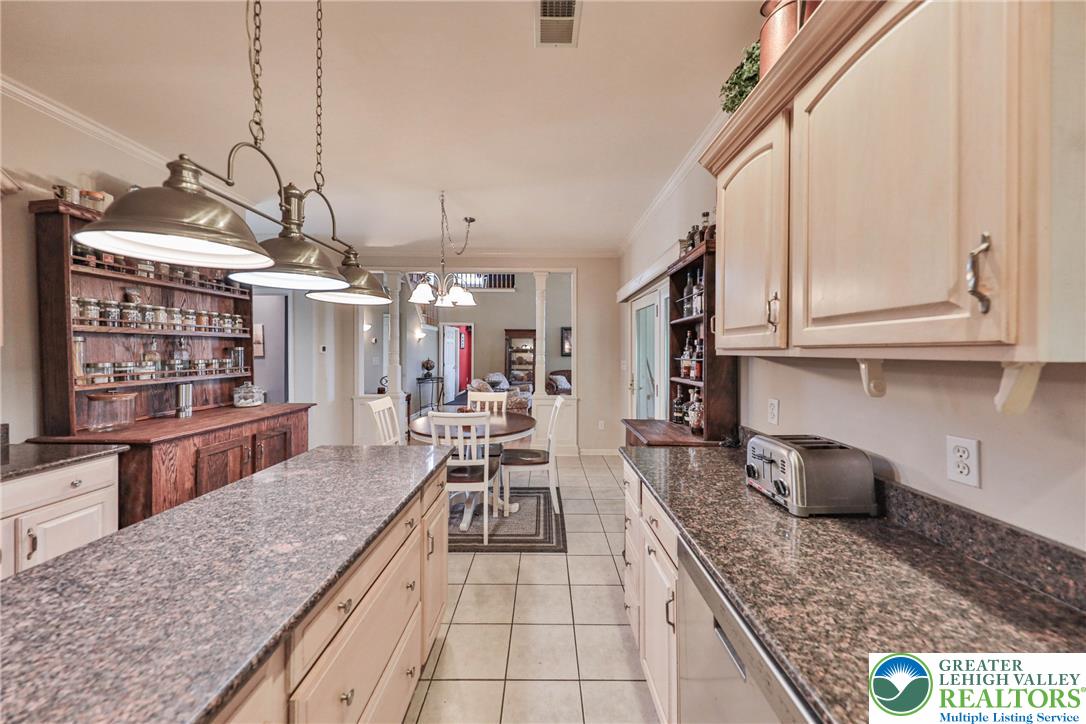 63 Long Road Lenhartsville, PA 19534 - Photo 48 of 100 Gleaming granite countertops and spacious cabinetry anchor this efficiently designed culinary space.