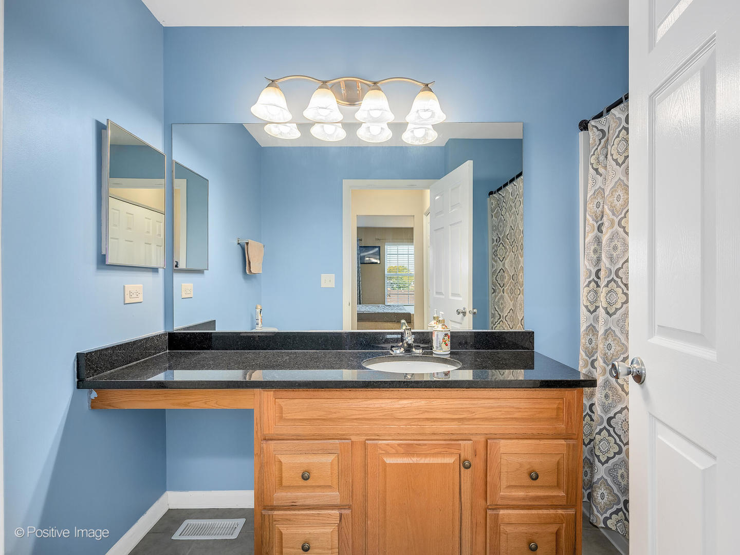 6567 Church Street Hanover Park, IL 60133 - Photo 11 of 19 a bathroom with a granite countertop sink and a mirror