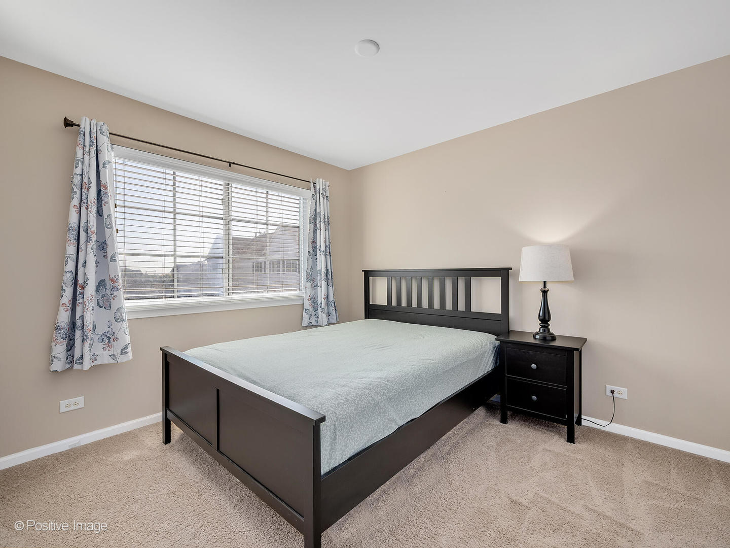 6567 Church Street Hanover Park, IL 60133 - Photo 12 of 19 a bed sitting in a bedroom next to a window