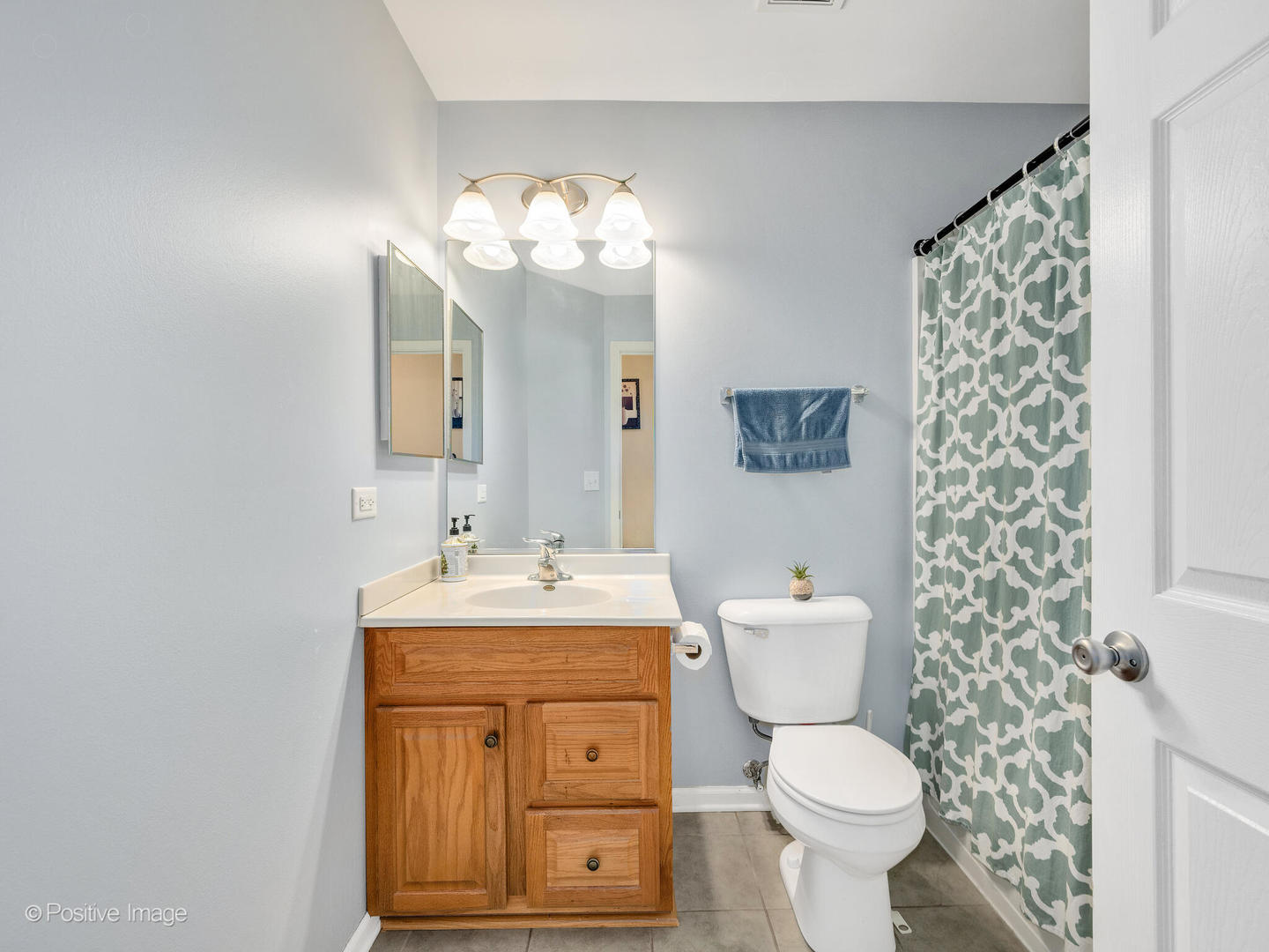 6567 Church Street Hanover Park, IL 60133 - Photo 13 of 19 a bathroom with a toilet sink and mirror