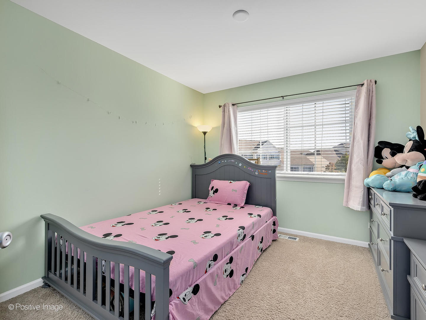 6567 Church Street Hanover Park, IL 60133 - Photo 14 of 19 a bedroom with a bed and windows