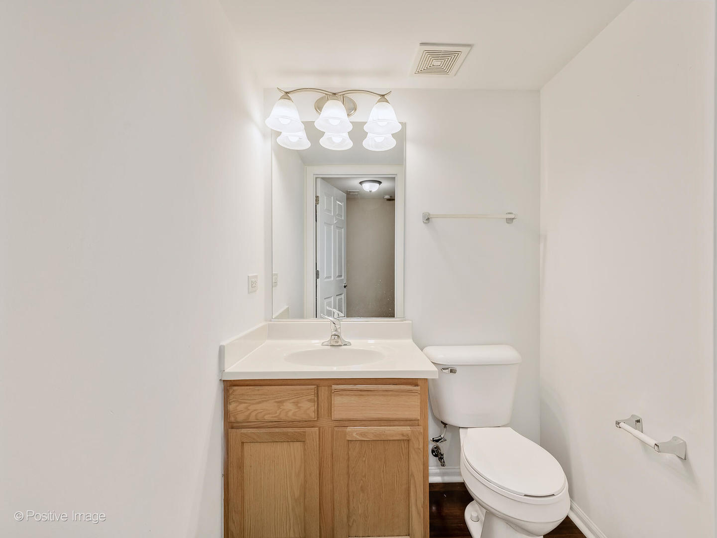 6567 Church Street Hanover Park, IL 60133 - Photo 17 of 19 a bathroom with a sink vanity mirror and toilet