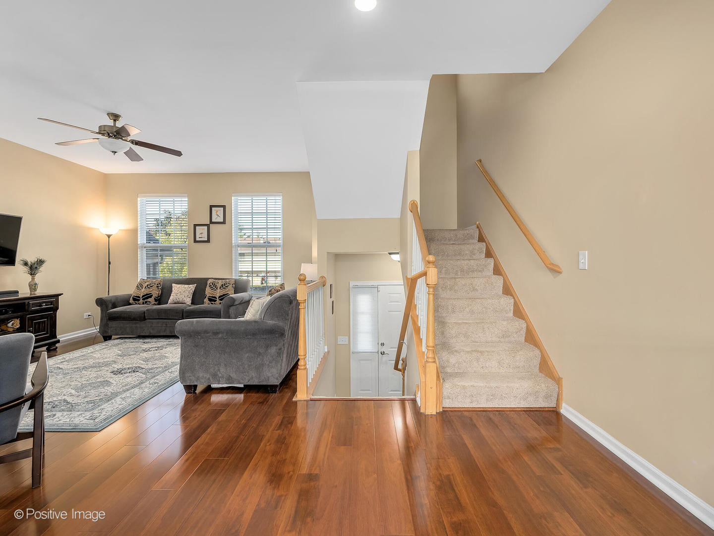 6567 Church Street Hanover Park, IL 60133 - Photo 2 of 19 a living room with couches and a dining table with wooden floor