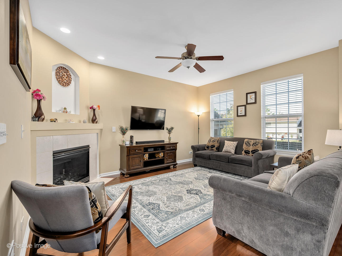 6567 Church Street Hanover Park, IL 60133 - Photo 4 of 19 a living room with furniture a fireplace and a flat screen tv