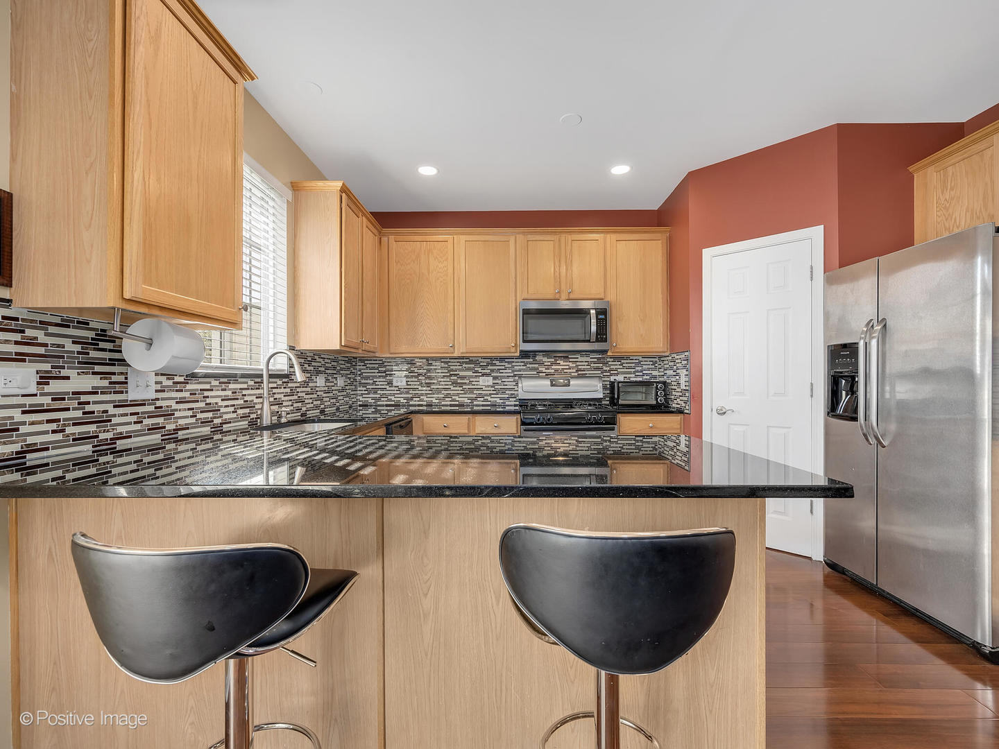 6567 Church Street Hanover Park, IL 60133 - Photo 6 of 19 a kitchen with stainless steel appliances granite countertop a sink and a refrigerator