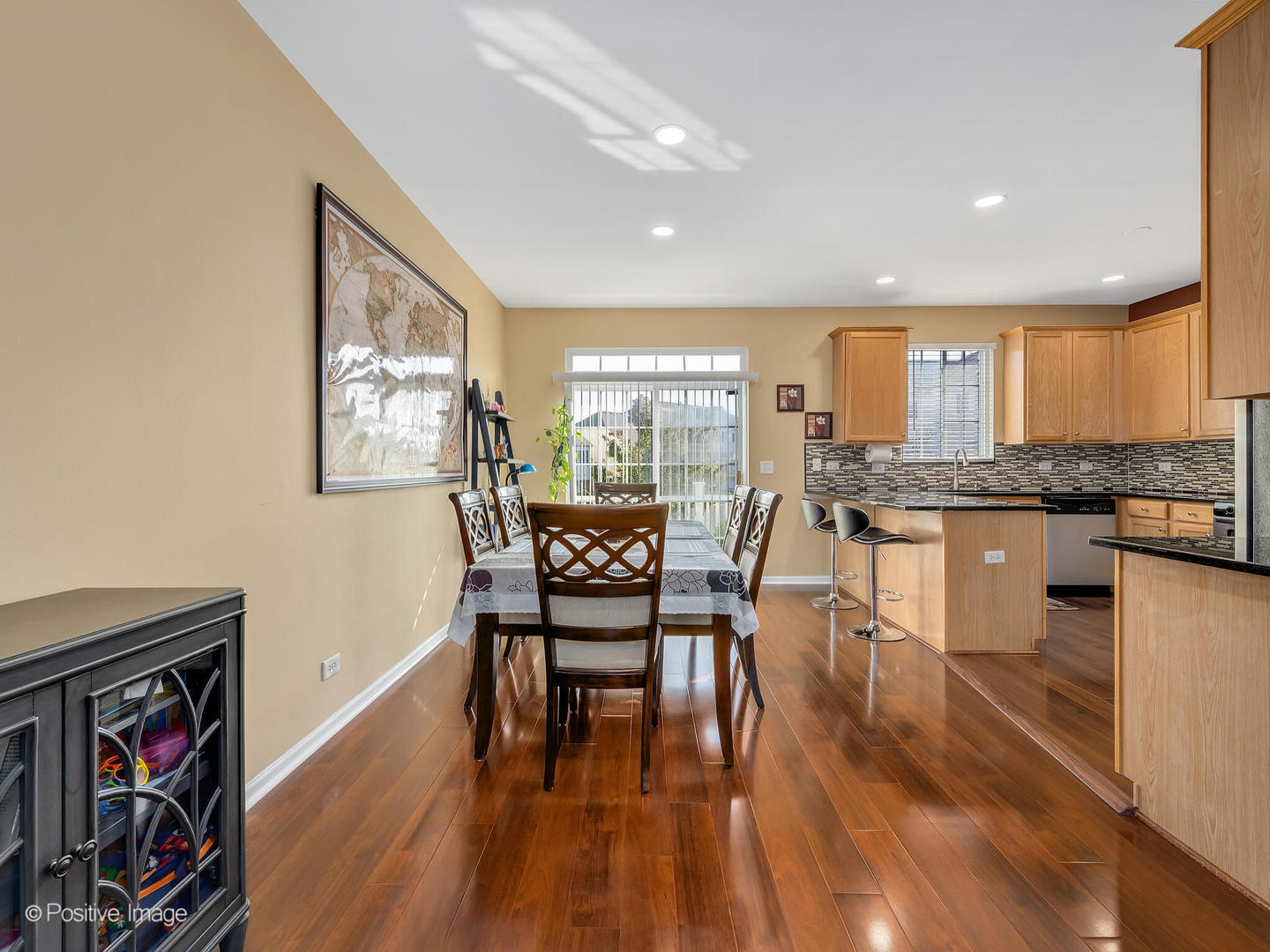 6567 Church Street Hanover Park, IL 60133 - Photo 8 of 19 a view of a dining room with furniture a rug and wooden floor