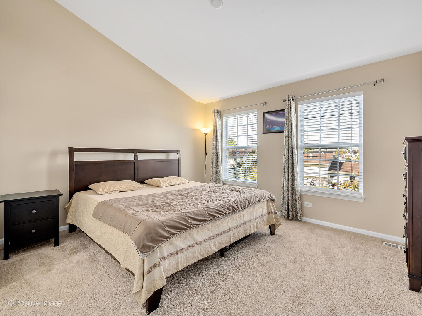 6567 Church Street Hanover Park, IL 60133 - Photo 10 of 19 a large bed sitting in a bedroom next to a window