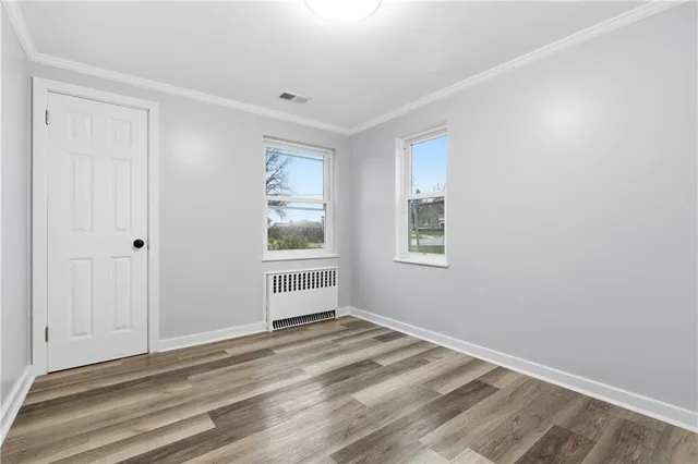 a view of a livingroom with wooden floor and a window