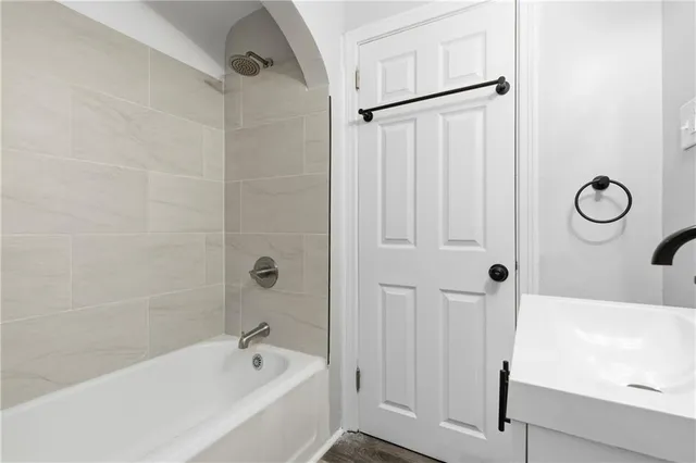 a bathroom with a bathtub a sink and a shower