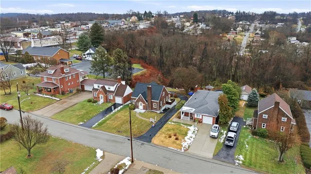 an aerial view of a house with a swimming pool