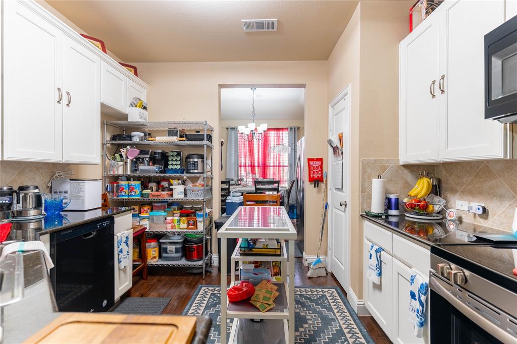 1219 Mount Olive Lane Forney, TX 75126 - Photo 7 of 12 a utility room with lots of clutter and cabinets