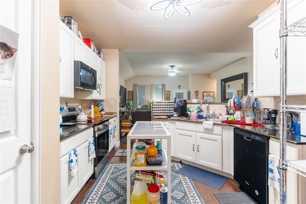 1219 Mount Olive Lane Forney, TX 75126 - Photo 8 of 12 a kitchen that has a lot of cabinets in it