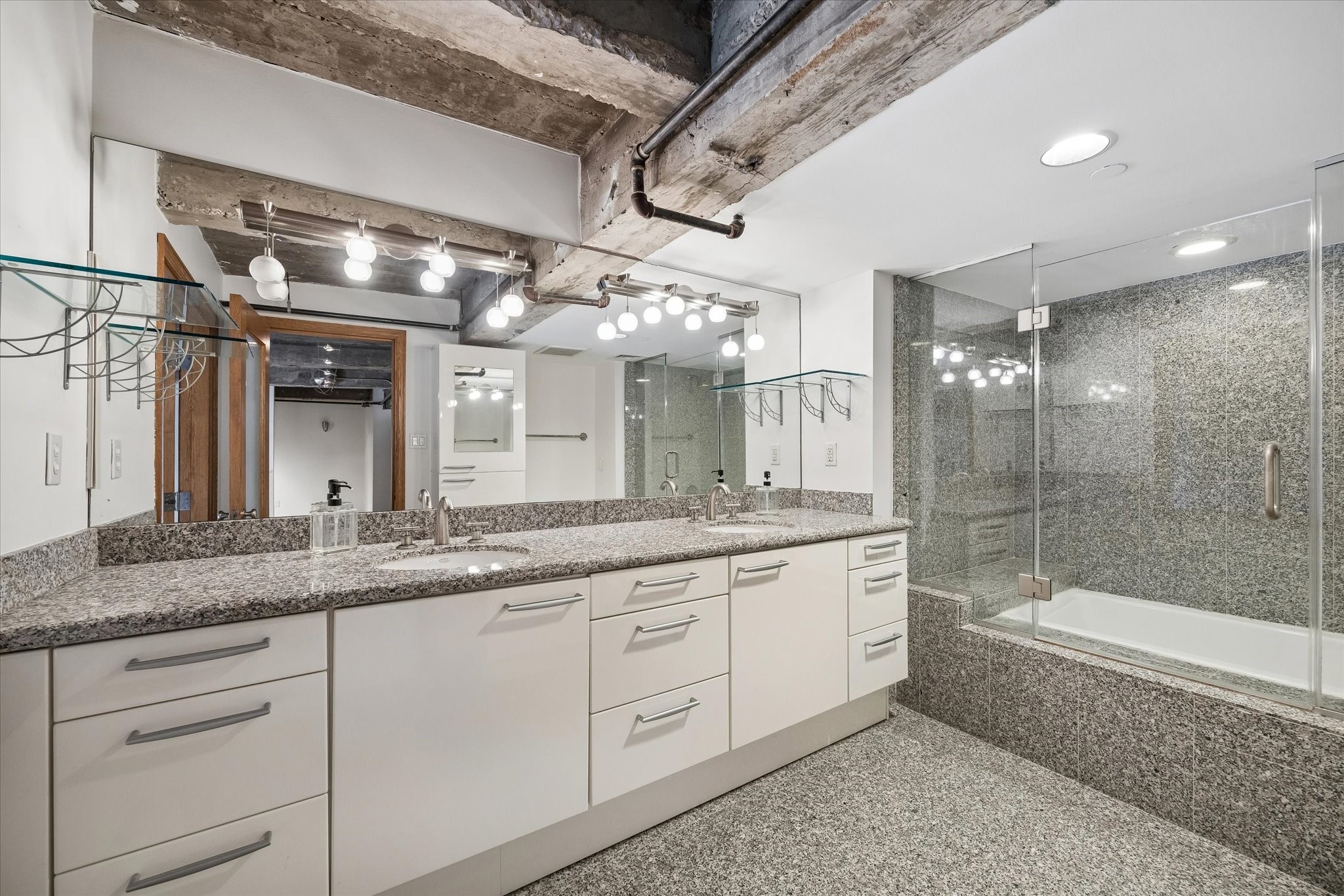 915 Franklin Street, Unit 9L Houston, TX 77002 - Photo 30 of 50 Additional view of the primary bathroom highlighting ample storage and a glass-enclosed shower/tub.