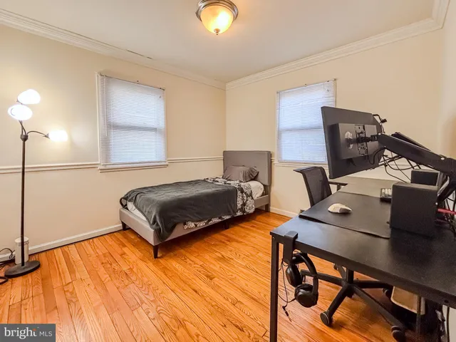 a bedroom with furniture and a wooden floor