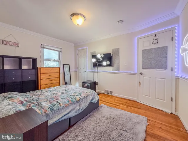 a bedroom with a bed and dresser