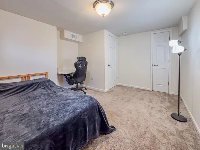 a bedroom with a bed and cabinets