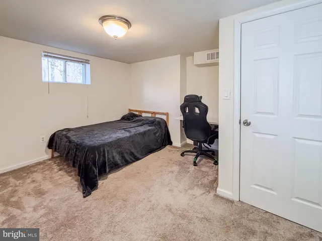 a bedroom with a bed and table chair