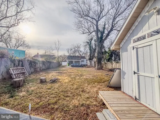 a front view of a house with a yard covered with snow