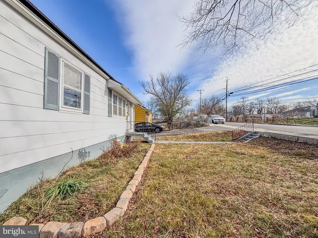 a view of a house with a yard covered in snow