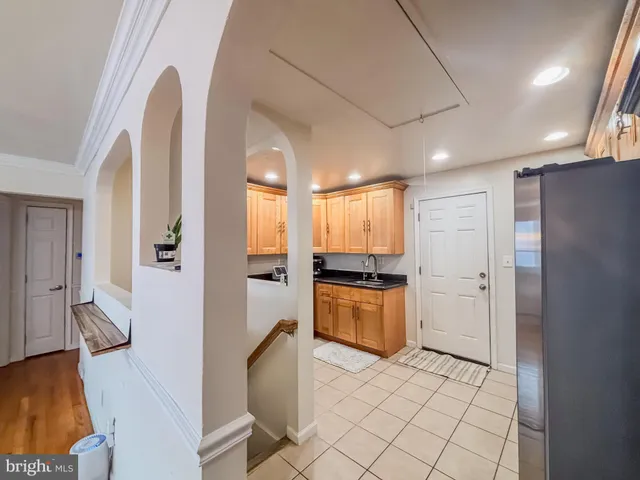 a large kitchen with stainless steel appliances a refrigerator and a stove top oven