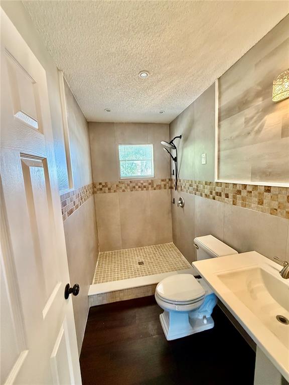 8124 Cormel Street, Unit 8126 Port Richey, FL 34668 - Photo 10 of 13 a bathroom with a sink a toilet and shower