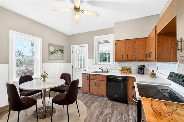 a kitchen that has a cabinets counter space dining table and a sink