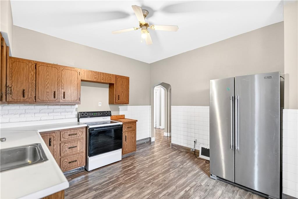 1107 Reeves Avenue Monessen, PA 15062 - Photo 14 of 33 a kitchen with stainless steel appliances a stove a refrigerator and a cabinets