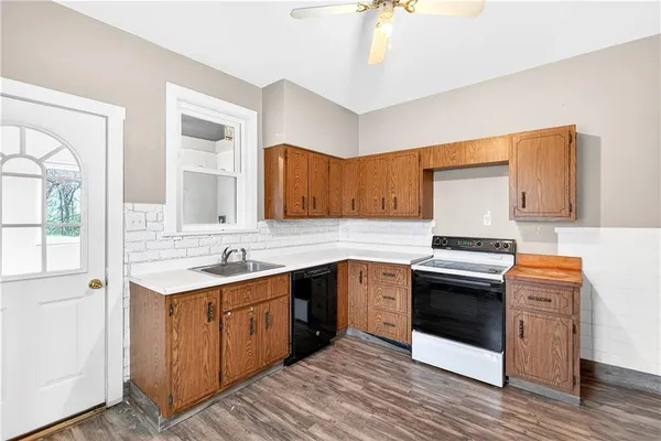 a kitchen with stainless steel appliances granite countertop a sink stove and cabinets