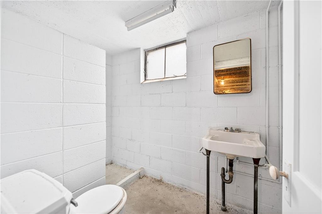 1107 Reeves Avenue Monessen, PA 15062 - Photo 31 of 33 a bathroom with a sink a toilet and mirror