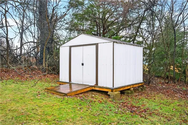 a backyard of a house with a yard and seating space