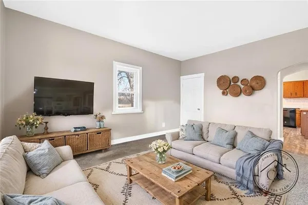 a living room with furniture and a flat screen tv
