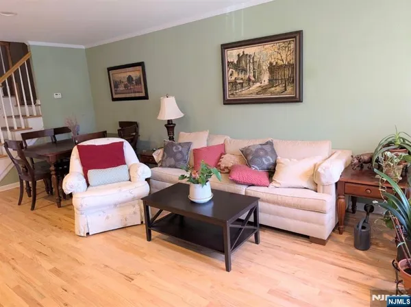 a living room with furniture plant and a window