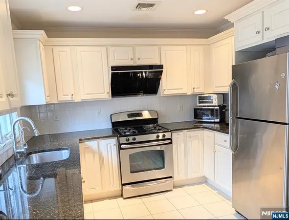 a view of a dining room with furniture and a window