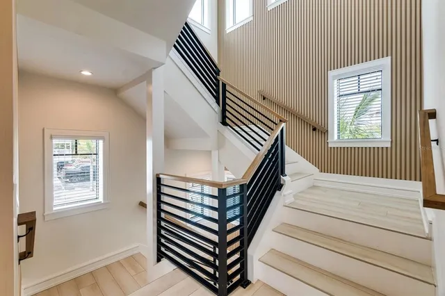 a bedroom with a large bed and a large window