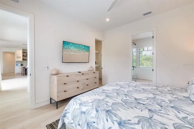 a bed sitting in a bedroom next to a window