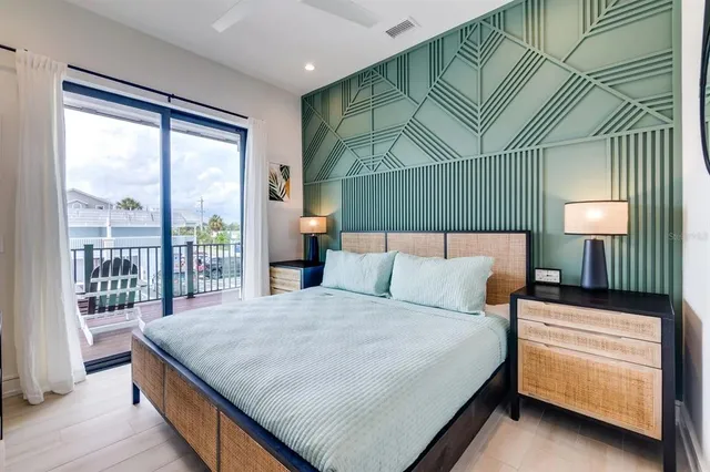 a bedroom with a large bed and a chandelier