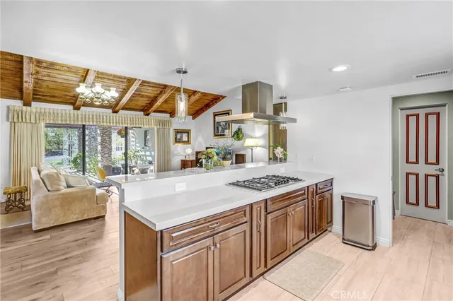 a view of a dining room with furniture wooden floor and a chandelier