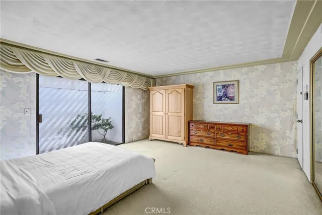 a bathroom with a granite countertop tub sink a mirror a vanity and next to a window