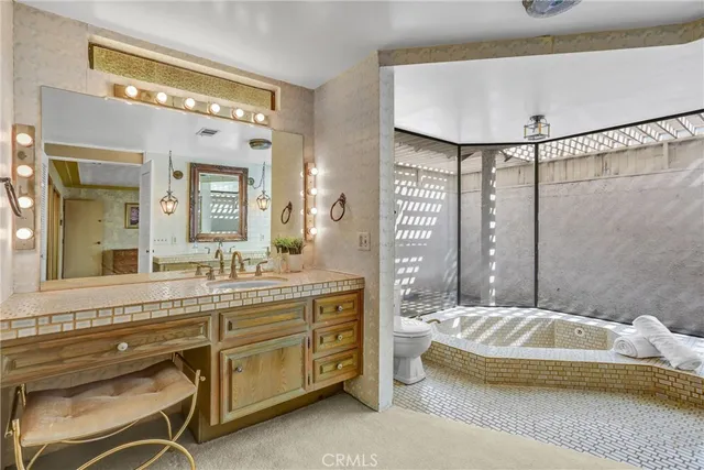 a spacious bathroom with a granite countertop sink a mirror and a shower