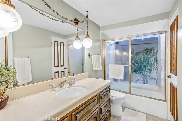 a spacious bathroom with a granite countertop sink mirror and a shower