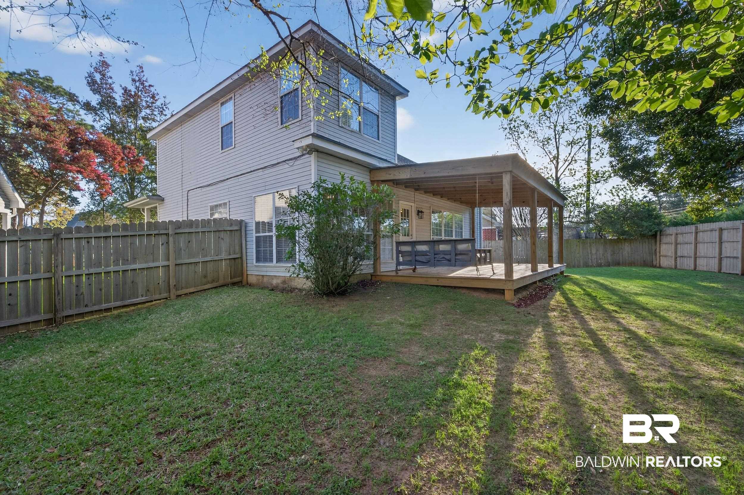 7050 Highpointe Place West Daphne, AL 36527 - Photo 42 of 66 Back of house featuring a fenced backyard and a wooden deck