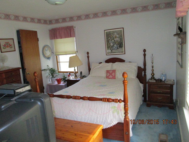 3585 Hamlin Road Lizella, GA 31052 - Photo 11 of 12 a bed room with a bed mirror and a desk