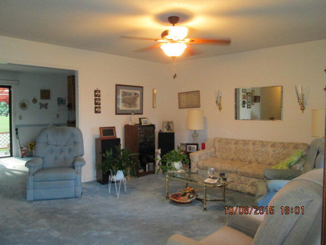3585 Hamlin Road Lizella, GA 31052 - Photo 4 of 12 a living room with furniture and a chandelier