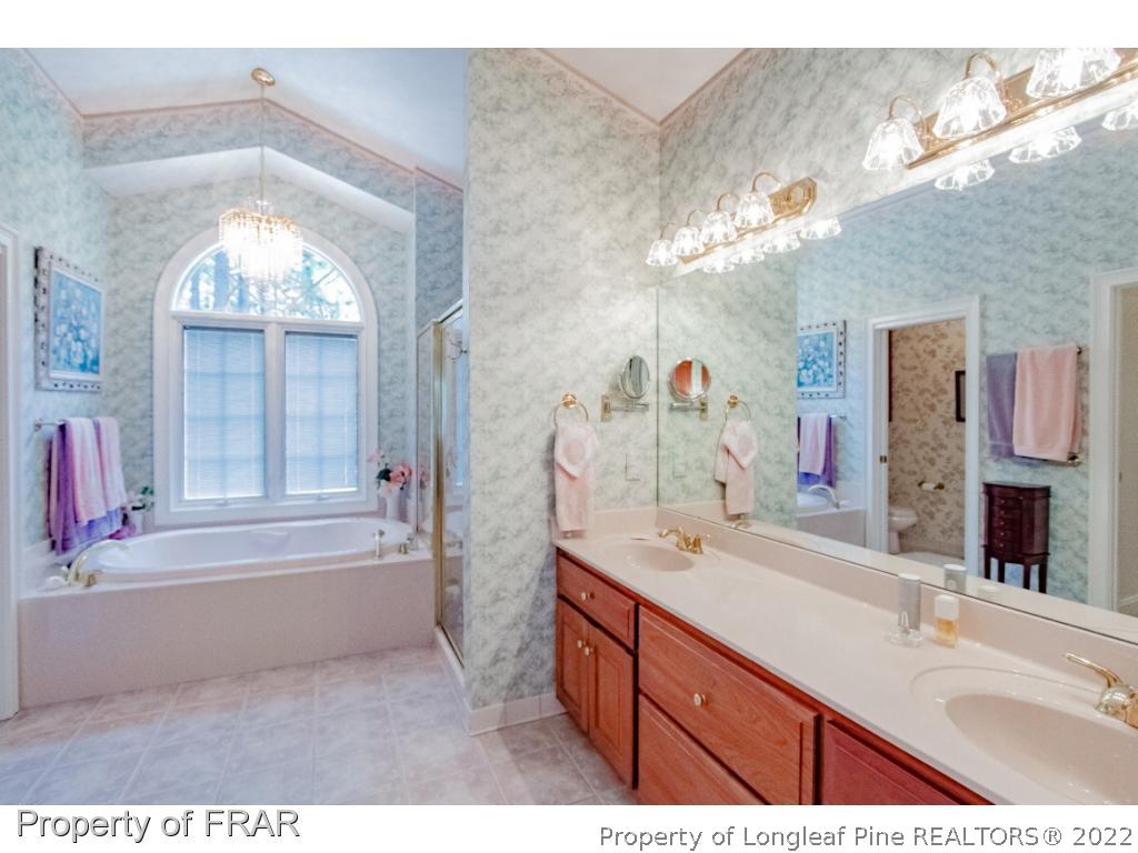 127 Harrell Road West End, NC 27376 - Photo 14 of 27 a bathroom with a tub sink and a mirror