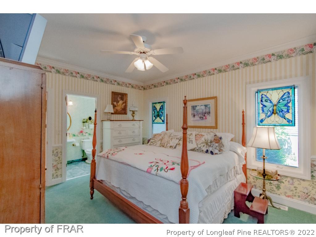 127 Harrell Road West End, NC 27376 - Photo 15 of 27 a bed room with a bed mirror and a window