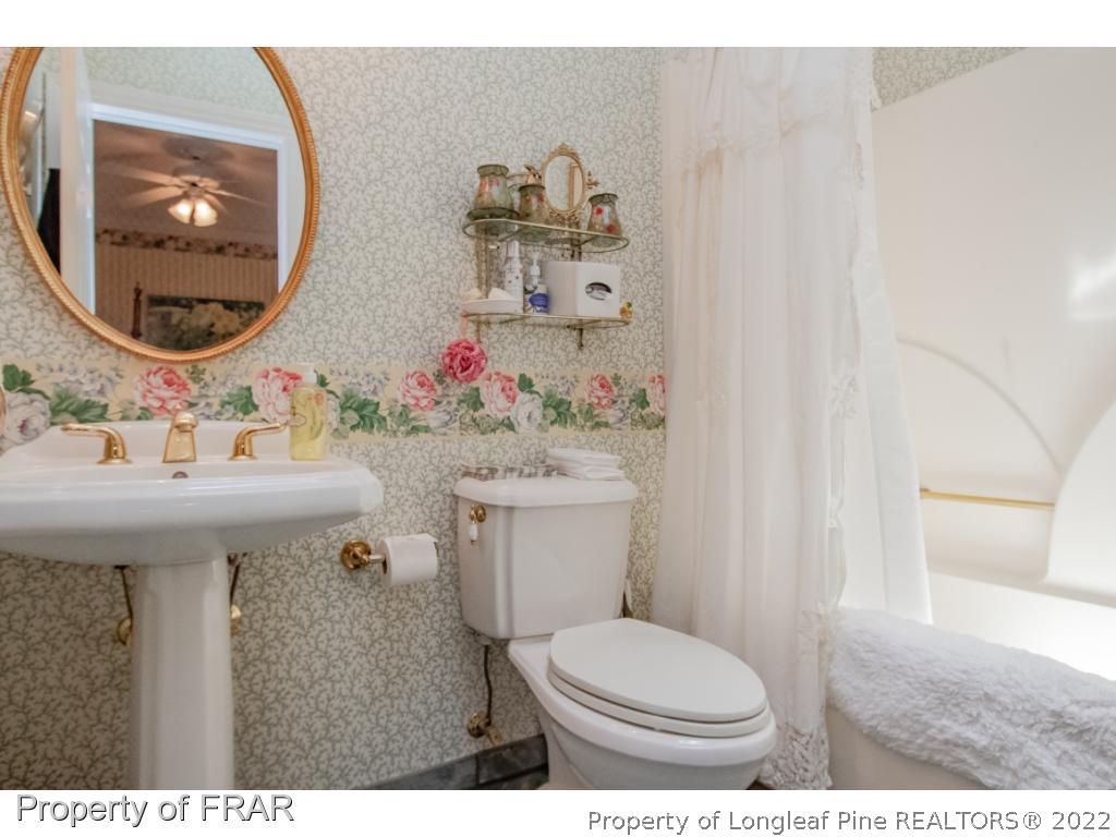 127 Harrell Road West End, NC 27376 - Photo 16 of 27 a bathroom with a sink mirror and toilet