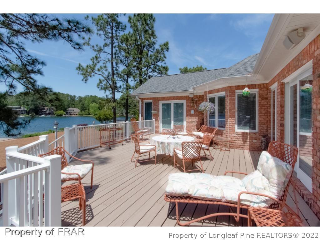 127 Harrell Road West End, NC 27376 - Photo 21 of 27 a view of a patio with couches chairs and a table and chairs with wooden floor