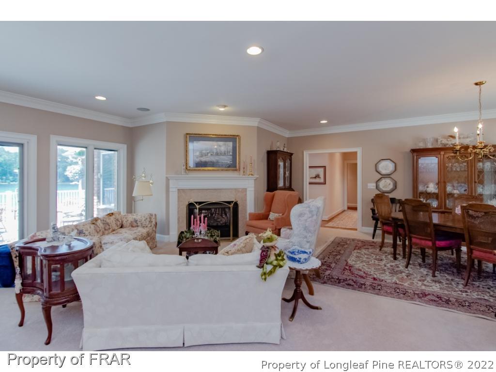 127 Harrell Road West End, NC 27376 - Photo 10 of 27 a living room with furniture a dining table and a fireplace