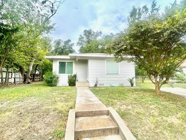 a house with trees in the background